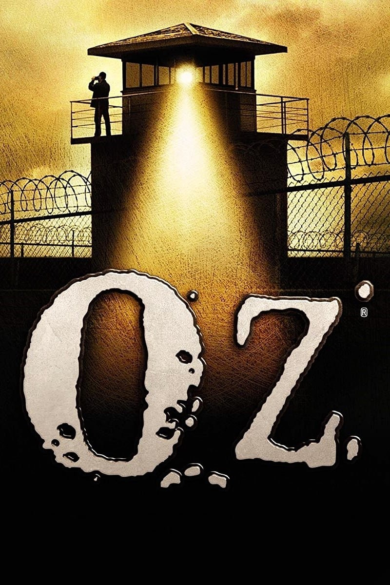 TV show Oz poster: silhouetted guard in a lit prison watchtower, barbed wire fence, and bold 'Oz' title in the foreground.