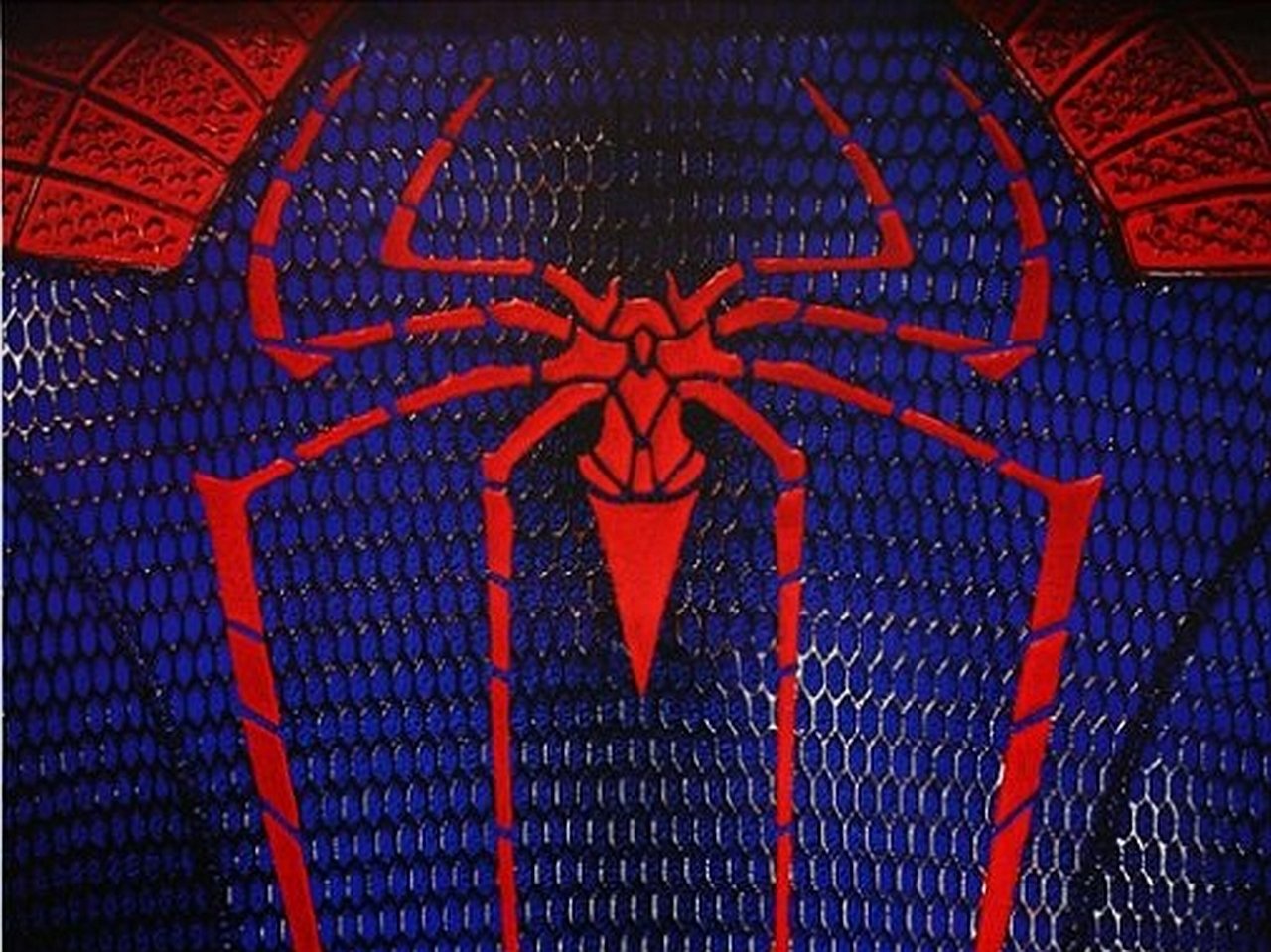 Close-up of a textured blue and red suit from The Amazing Spider-Man, featuring the iconic spider emblem prominently displayed on the chest.