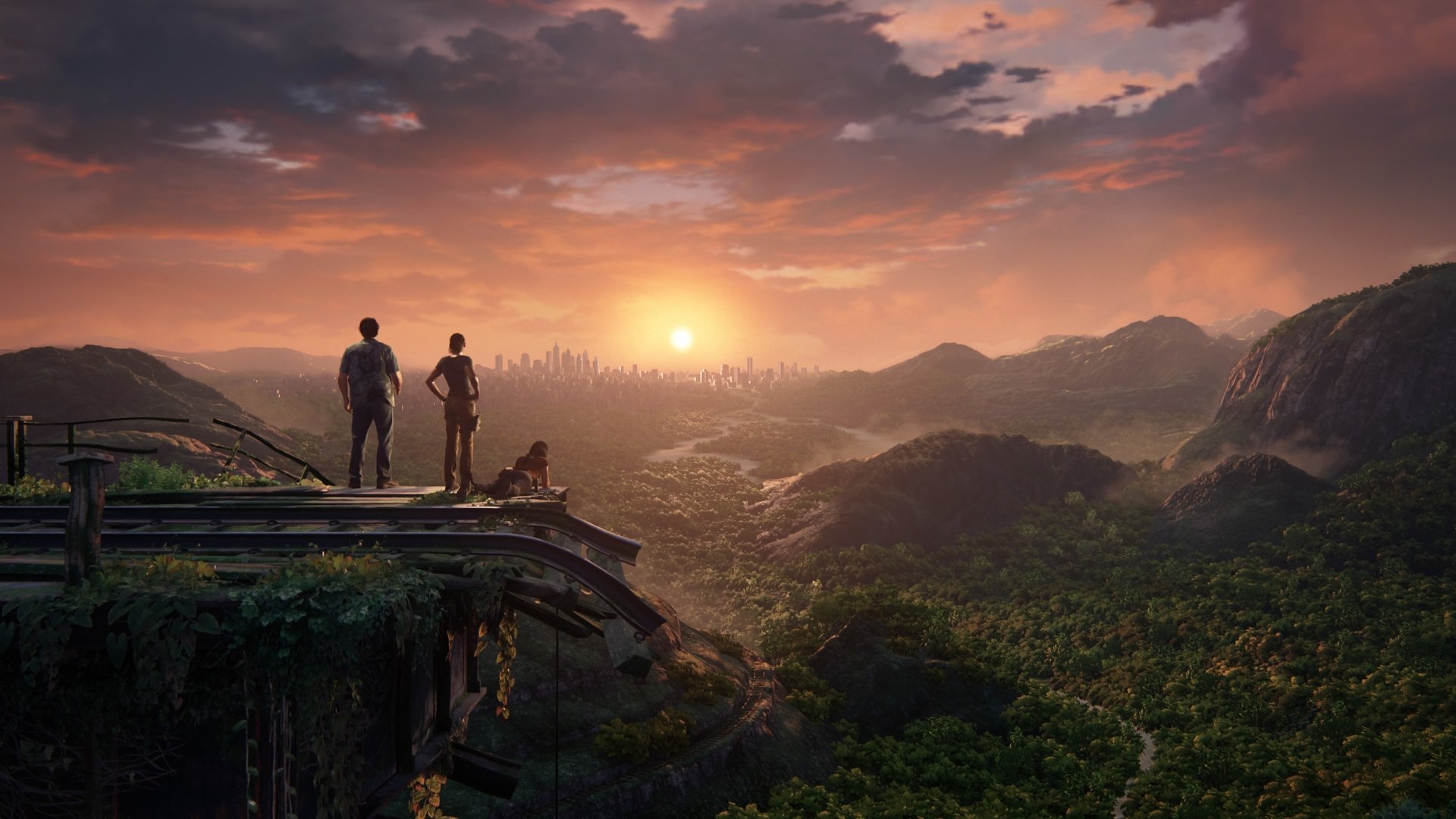 Samuel Drake and Chloe Frazer stand on a cliff overlooking a vast jungle landscape at sunset, with Nadine Ross nearby, from the video game Uncharted: The Lost Legacy.