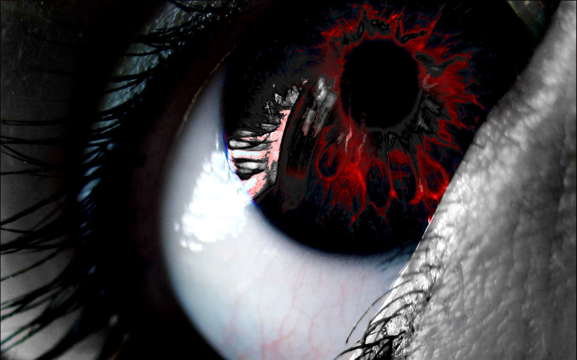 A dark, artistic close-up of an eye, featuring a striking red and black design within the iris, surrounded by textured skin and long eyelashes.