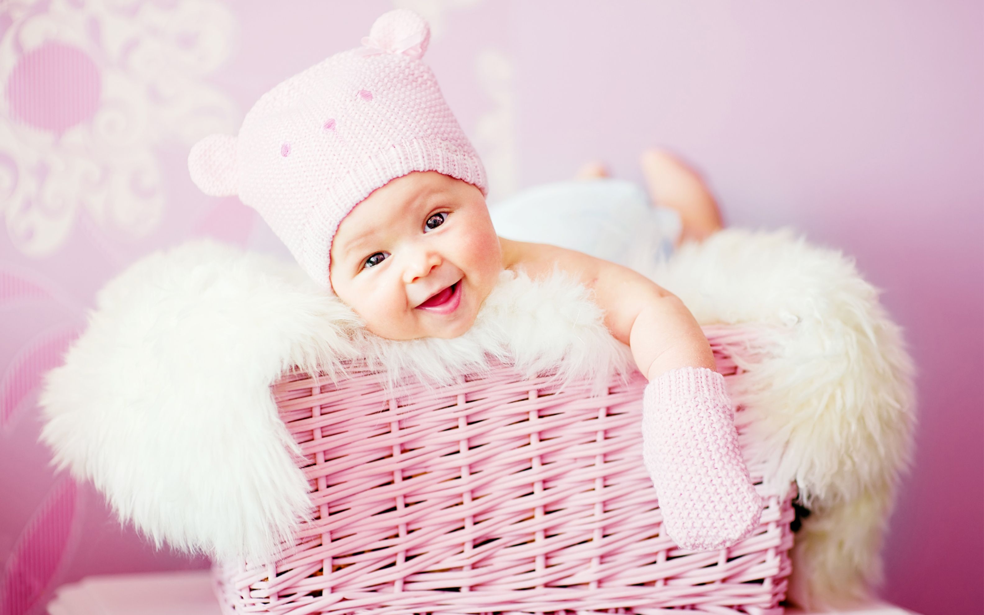 Cute Baby Girl in a Pink Wicker Basket.