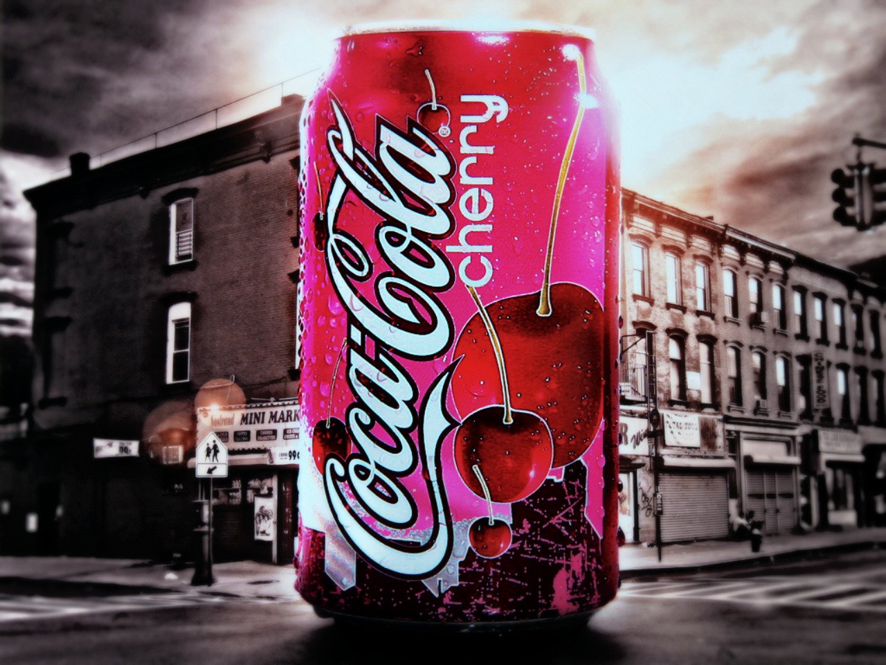 A vibrant red man-made Coca-Cola Cherry can is prominently displayed against a black and white urban street background at dusk.
