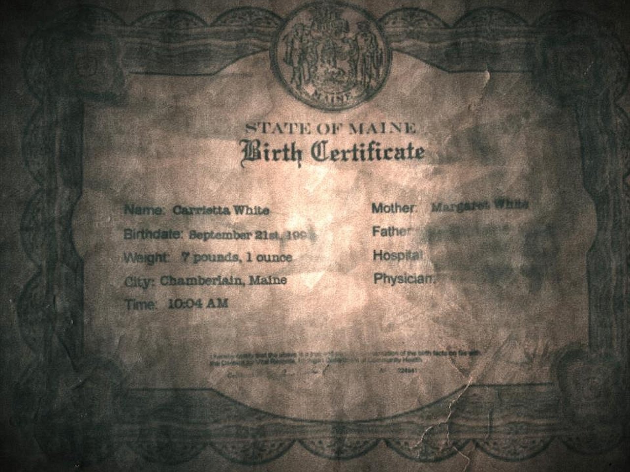 A weathered birth certificate from the movie Carrie (2013), showing details of Carrie White’s birth in Chamberlain, Maine.