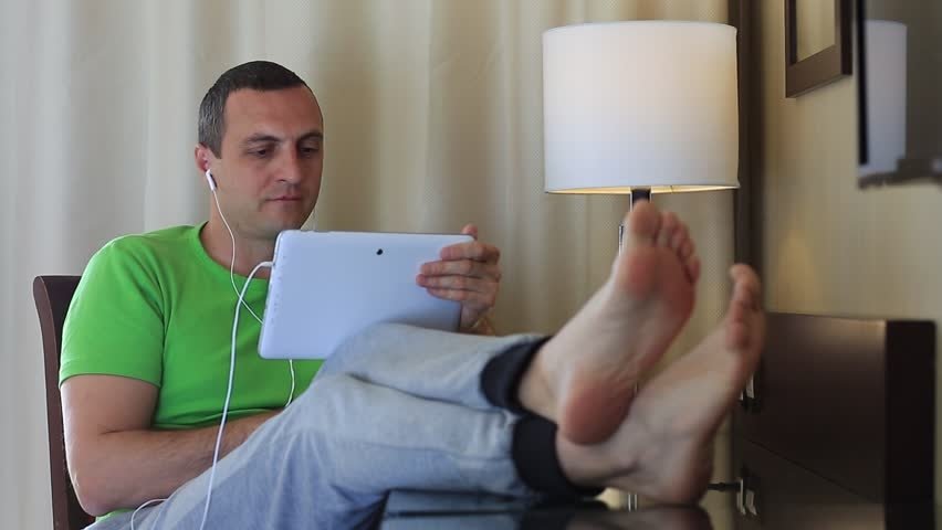 barefoot computer earbuds man feet Image