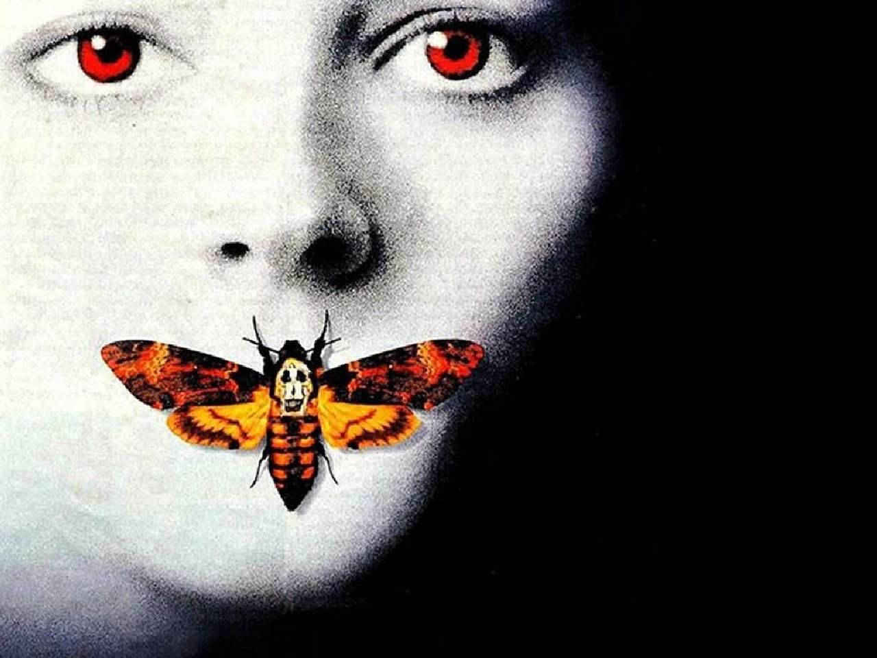 Close-up black-and-white portrait with red eyes and a colorful death's-head hawkmoth over the mouth, iconic imagery from the movie The Silence of the Lambs.