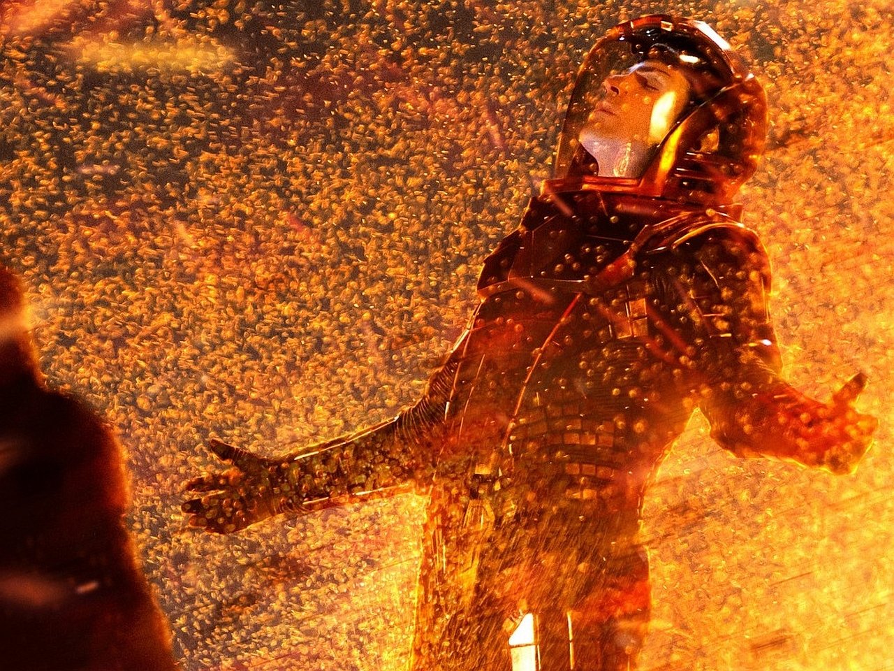A scene from the movie Star Trek Into Darkness showing a character in a spacesuit surrounded by fiery sparks and glowing embers.