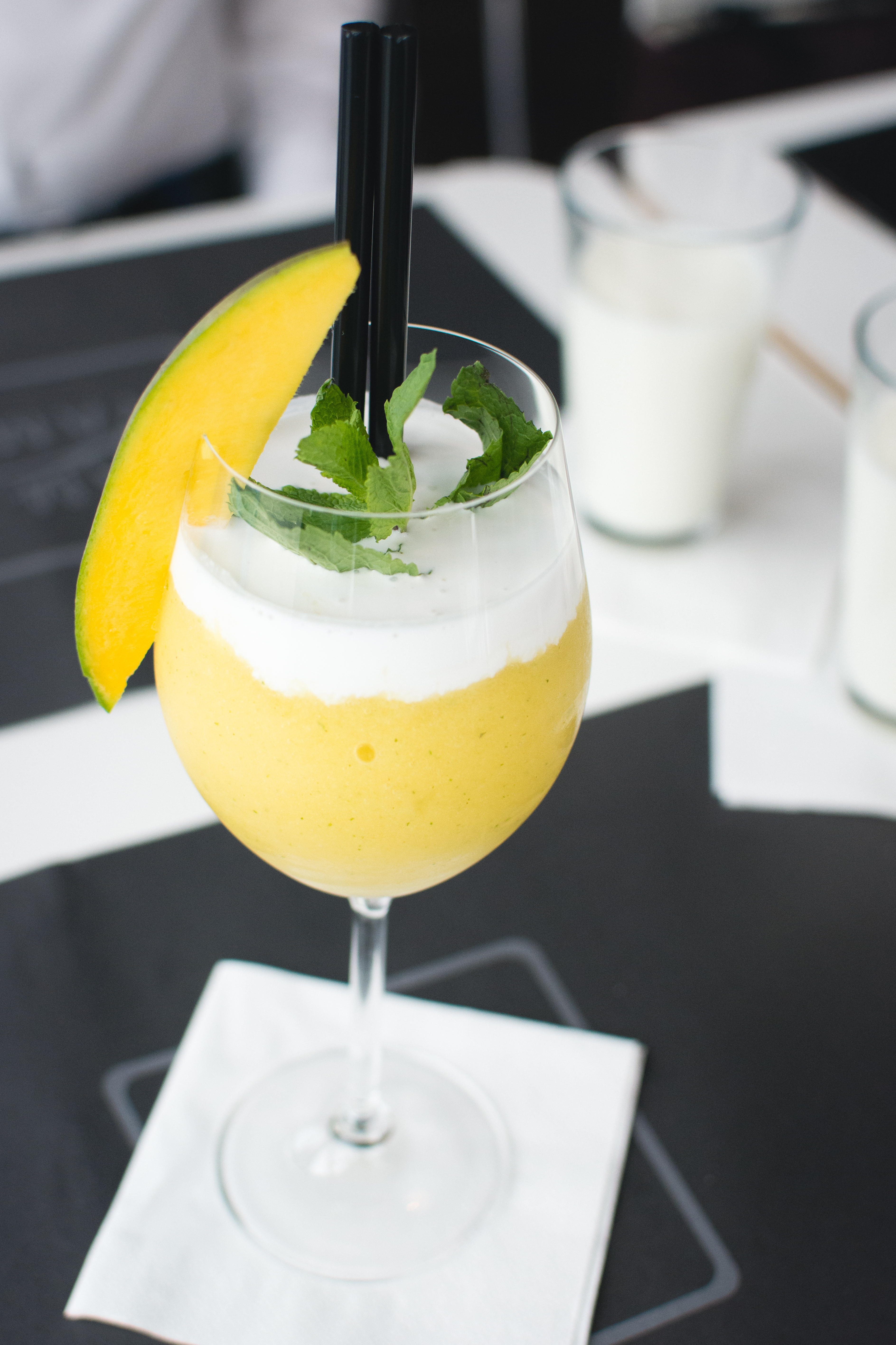 Frozen mango drink in a restaurant by Jakub Kapusnak