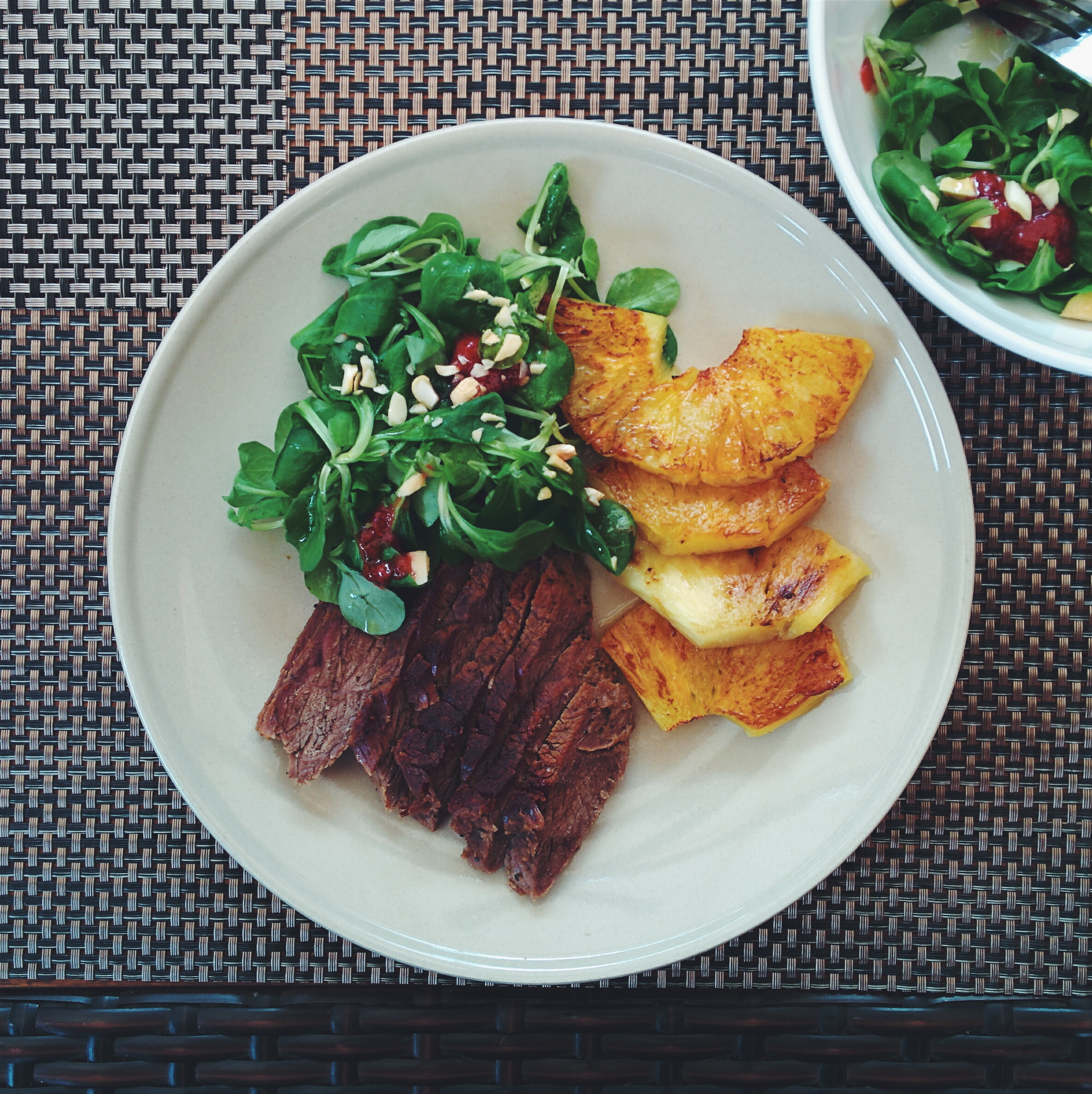 Roastbeef with grilled pineapple and greens by Jakub Kapusnak