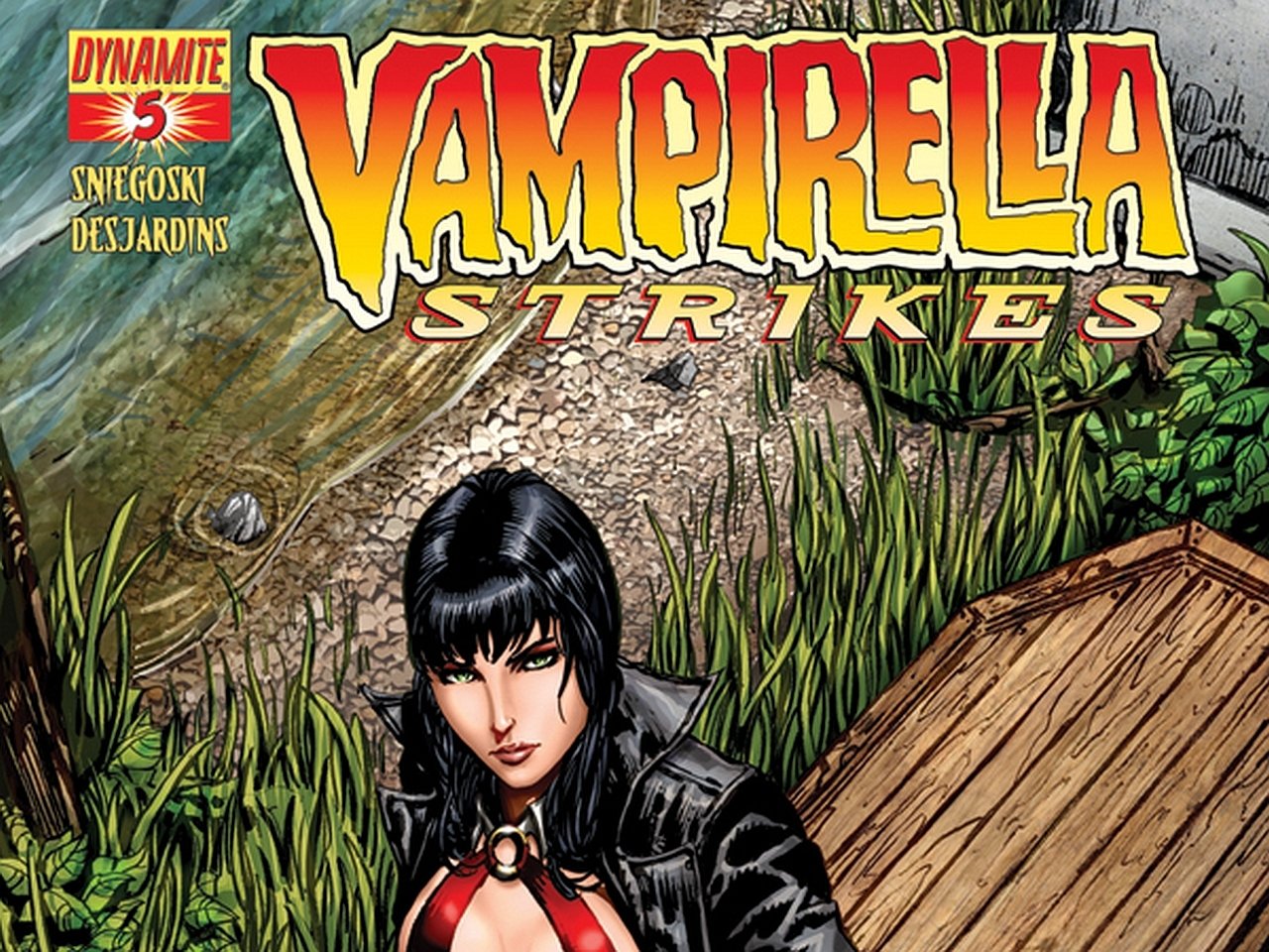 Comic cover — Vampirella Strikes: dark-haired Vampirella in a red costume and black cloak stands on a wooden dock beside reeds, title blazing overhead.