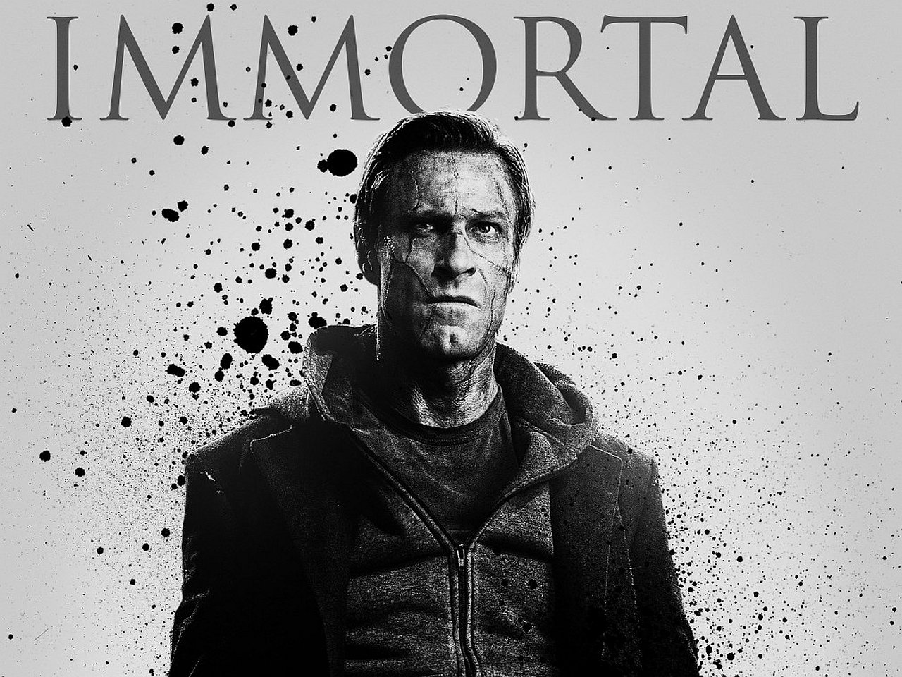 Promotional image for the movie I, Frankenstein, featuring a serious man with a dark hoodie against a splattered black and white background.