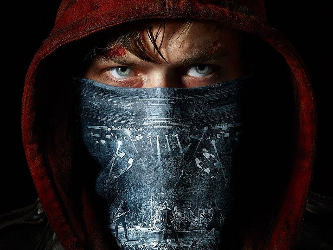Close-up of a person wearing a red hood and a face covering featuring a Metallica concert scene, promoting the movie Metallica Through the Never.