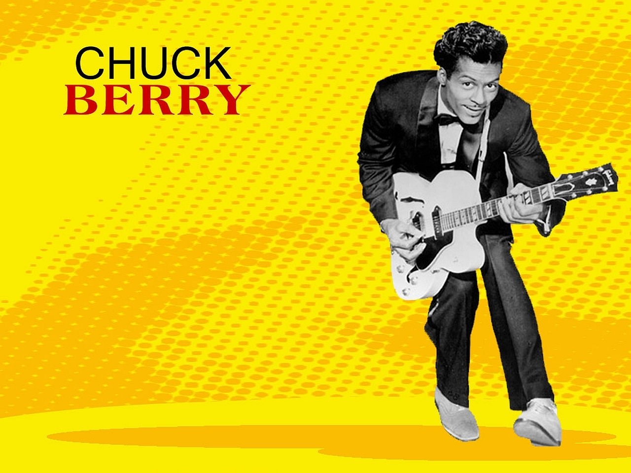 Black and white photo of Chuck Berry playing guitar against a vibrant yellow background, highlighting his iconic role in music history.