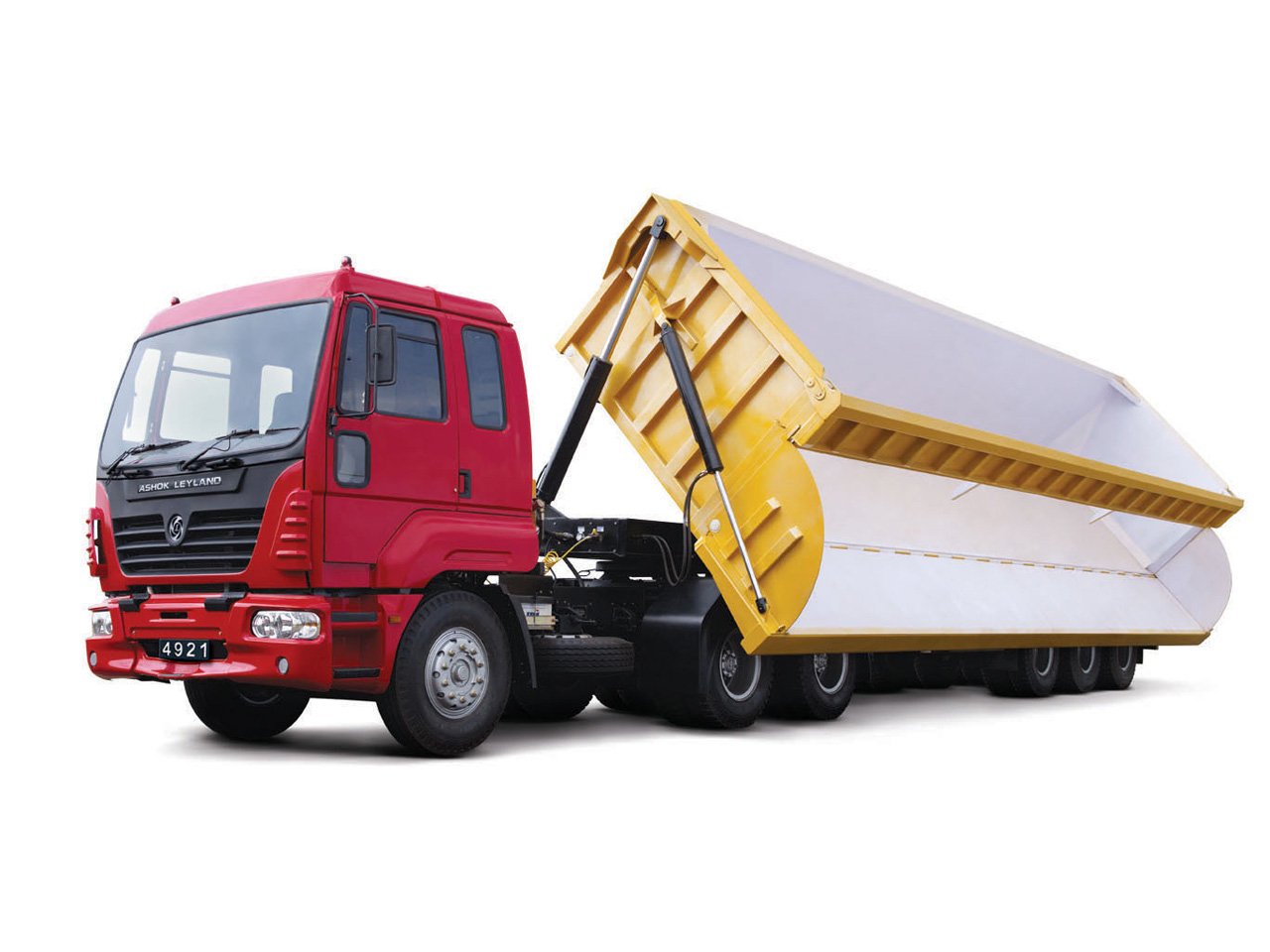 Red Ashok Leyland vehicle with a large yellow and white dump trailer in a raised position on a white background.
