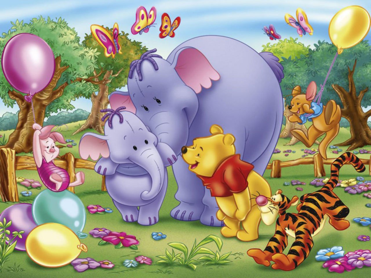 A colorful scene from the TV show Winnie the Pooh, featuring Pooh, Tigger, Piglet, and two elephants among flowers, balloons, and butterflies in a cheerful outdoor setting.