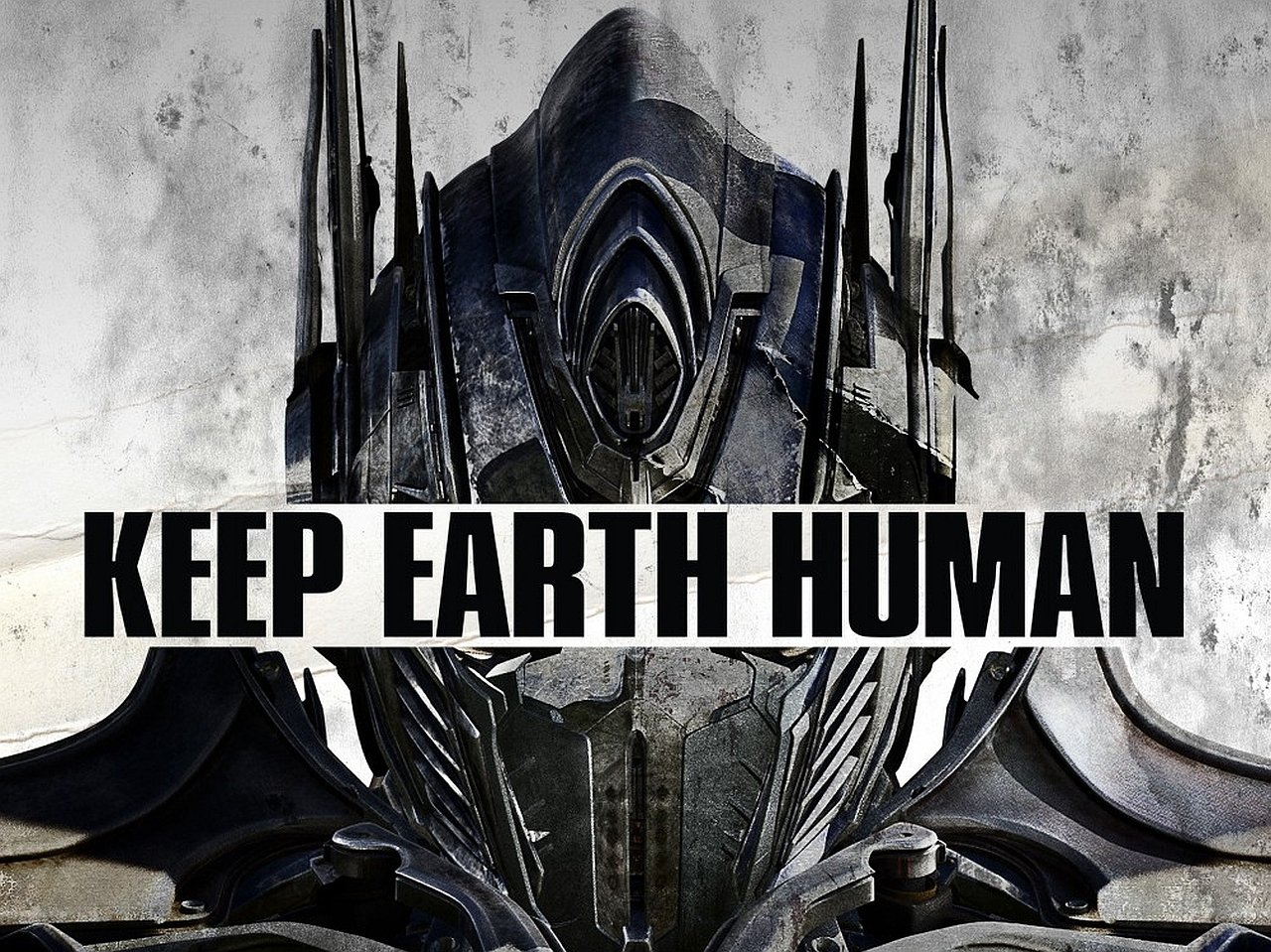 A bold image from *Transformers: Age of Extinction* featuring a menacing robotic face with the message KEEP EARTH HUMAN prominently displayed beneath.