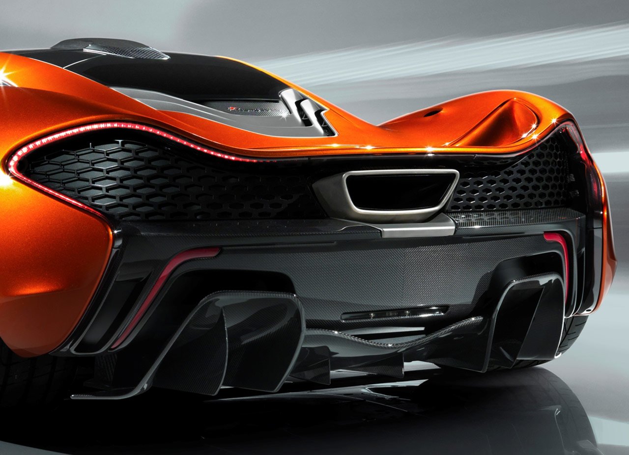 Rear view of an orange McLaren P1 showcasing its aerodynamic design and aggressive diffuser.