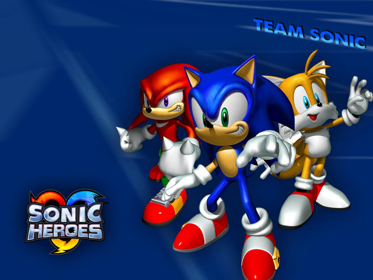 Sonic the Hedgehog, Miles Tails Prower, and Knuckles the Echidna pose dynamically with the Sonic Heroes logo and Team Sonic text on a blue background.