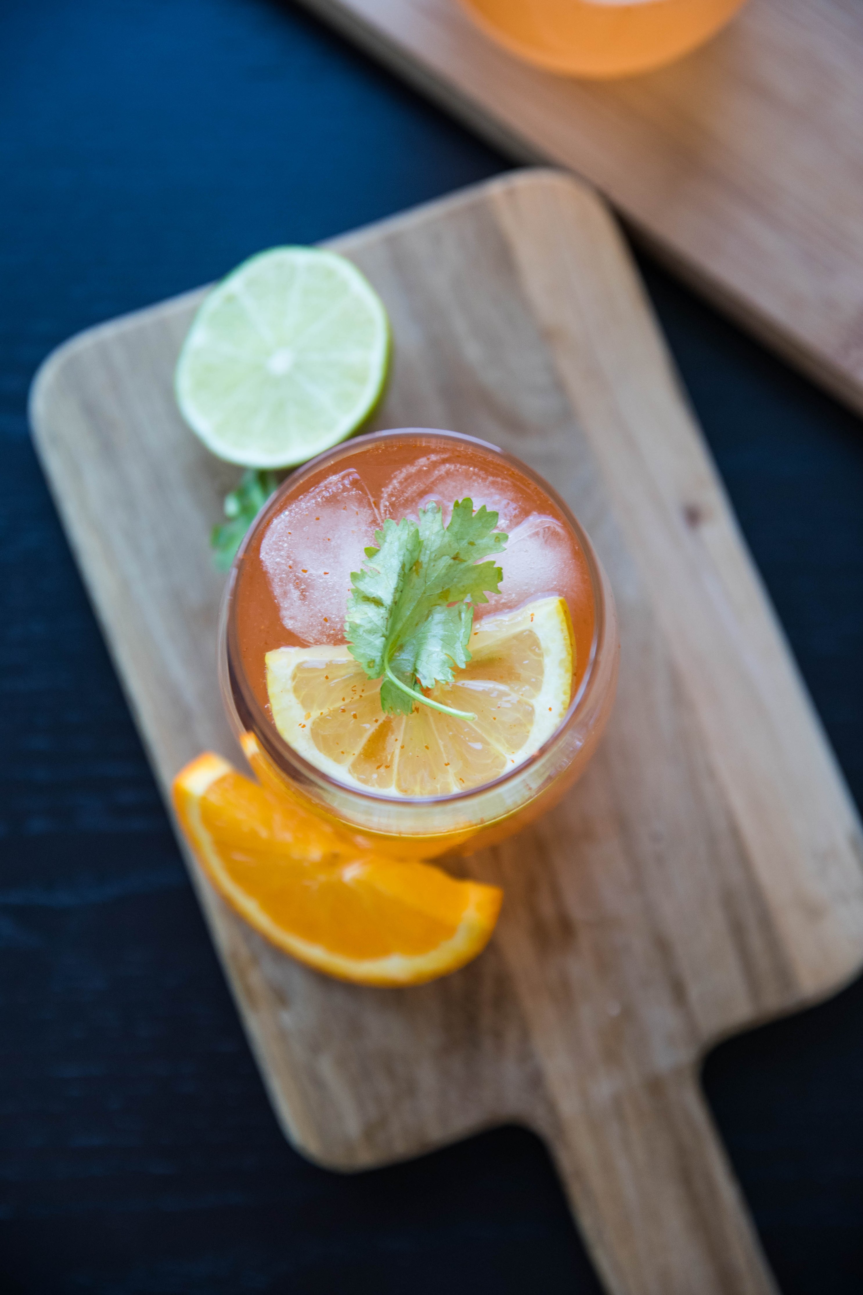Orange Beverage With Lime And Orange Garnish