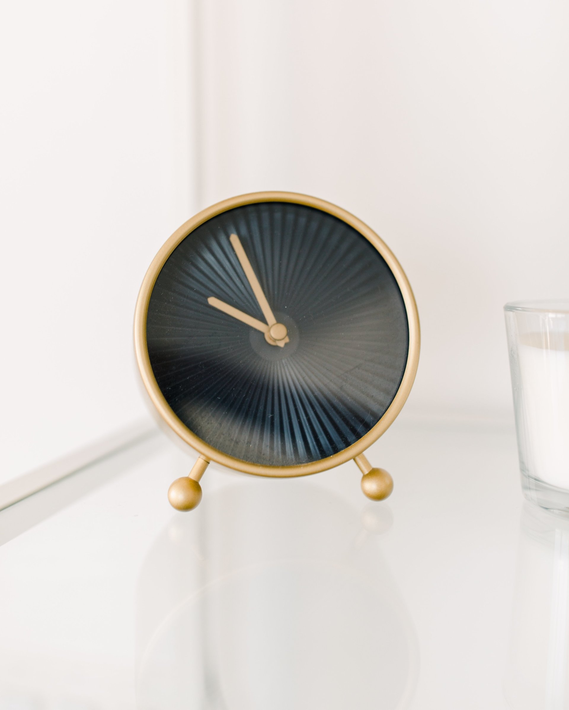  Black And Gold Clock On A White Table