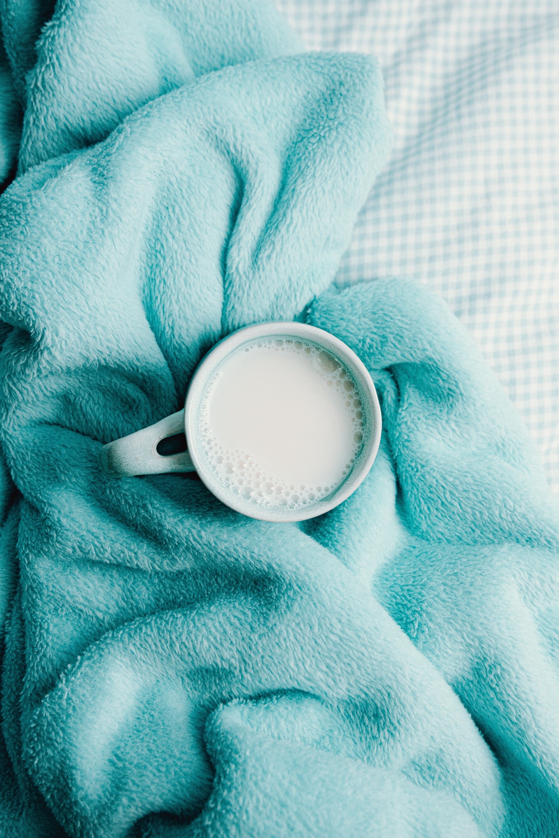  A Mug Surrounded By A Soft Blue Blanket