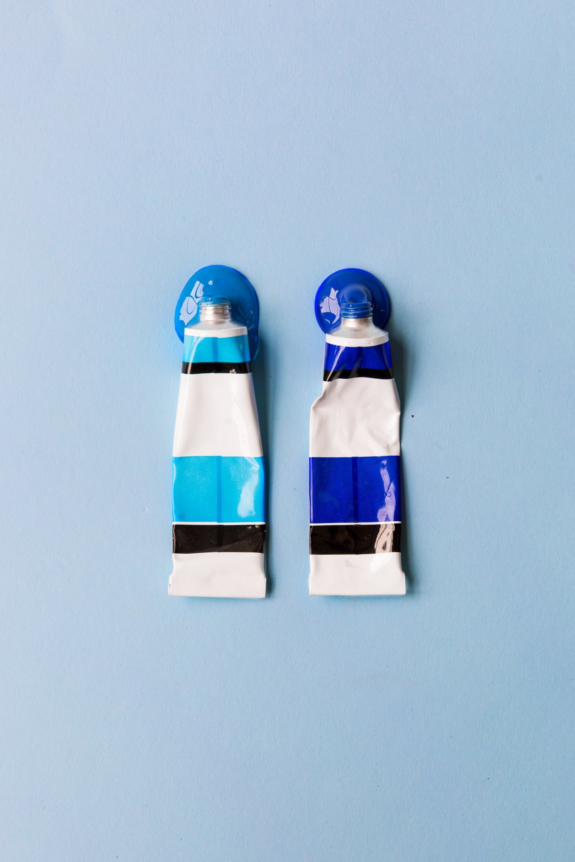  Two Tubes Of Blue Paint Spilling