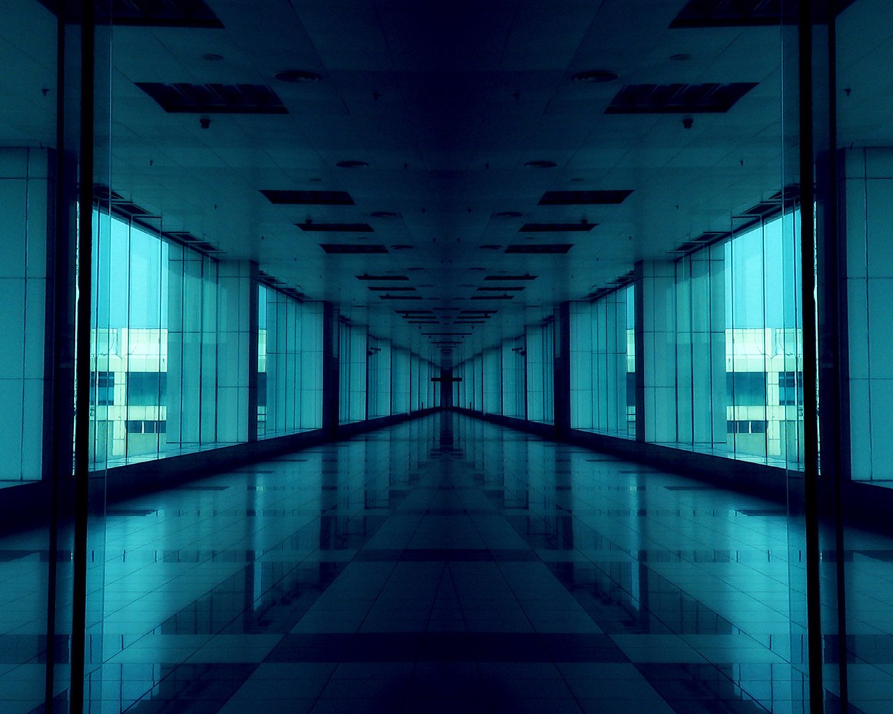 A futuristic hallway features reflective surfaces and a blue tint, creating a sci-fi atmosphere with a sense of depth and modern design.