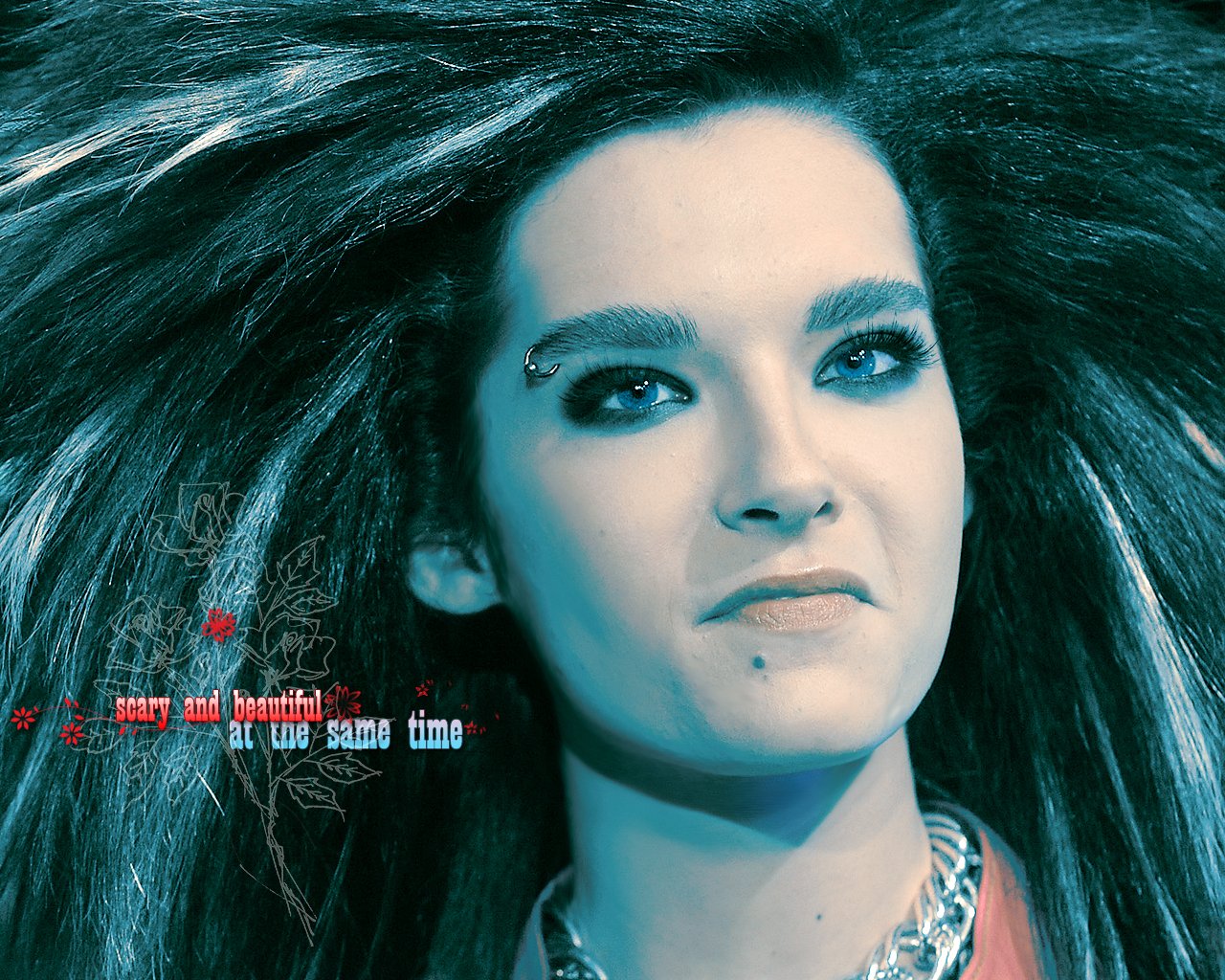 Close-up of a Tokio Hotel band member with dramatic hair and makeup, embodying the music group's distinctive style and intense stage presence.