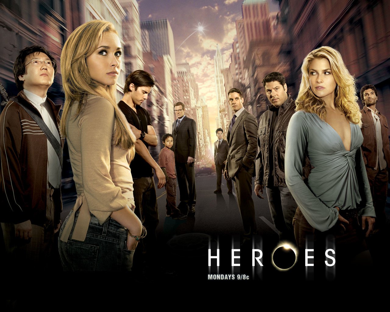 A group of diverse characters stands on a city street backdrop in a promotional image for the TV show Heroes, highlighting themes of power and destiny.