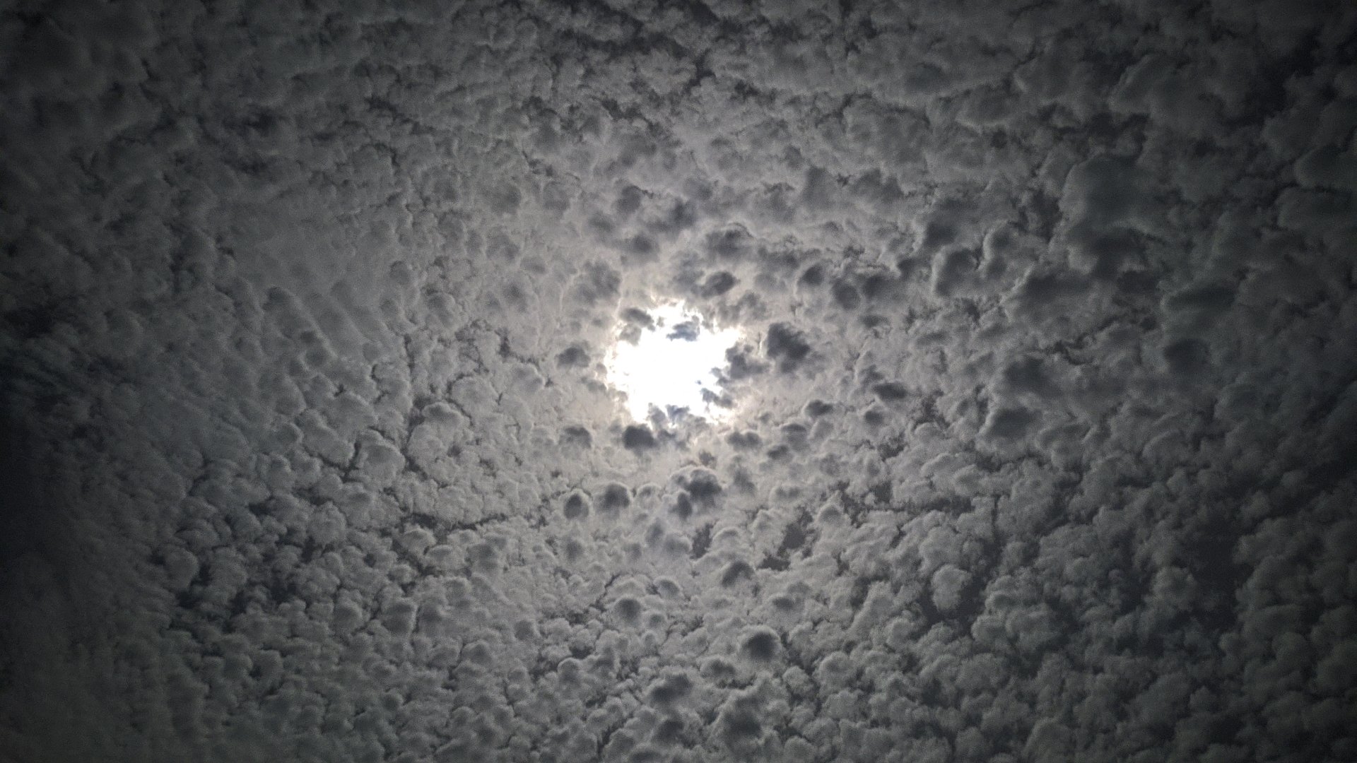  Moon behind cloudy sky