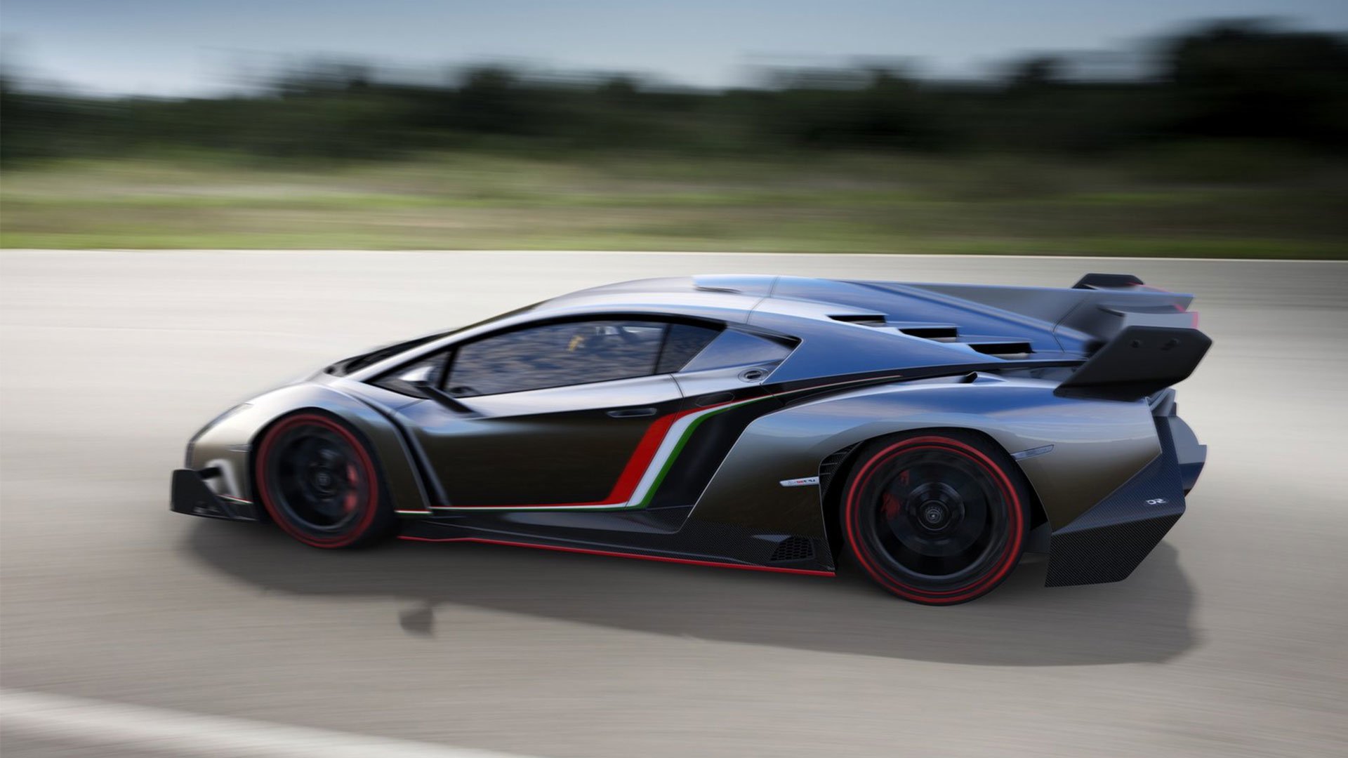 A sleek Lamborghini Veneno in motion, showcasing its aggressive design and striking colors. The high-performance vehicle conveys power and elegance on the open road.