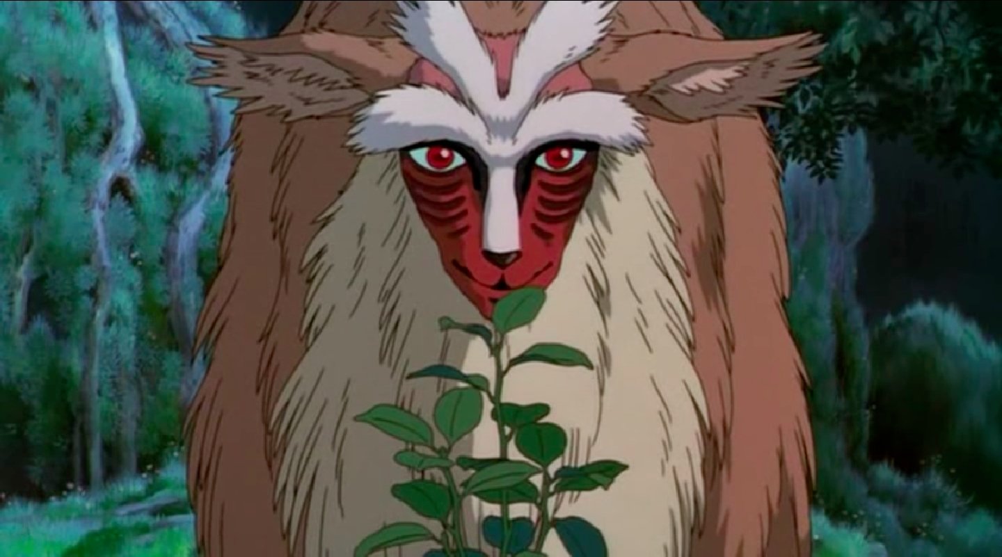 Anime — Princess Mononoke: a large furred forest spirit with a red-and-white mask-like face clutching a small sapling in a dark woodland.