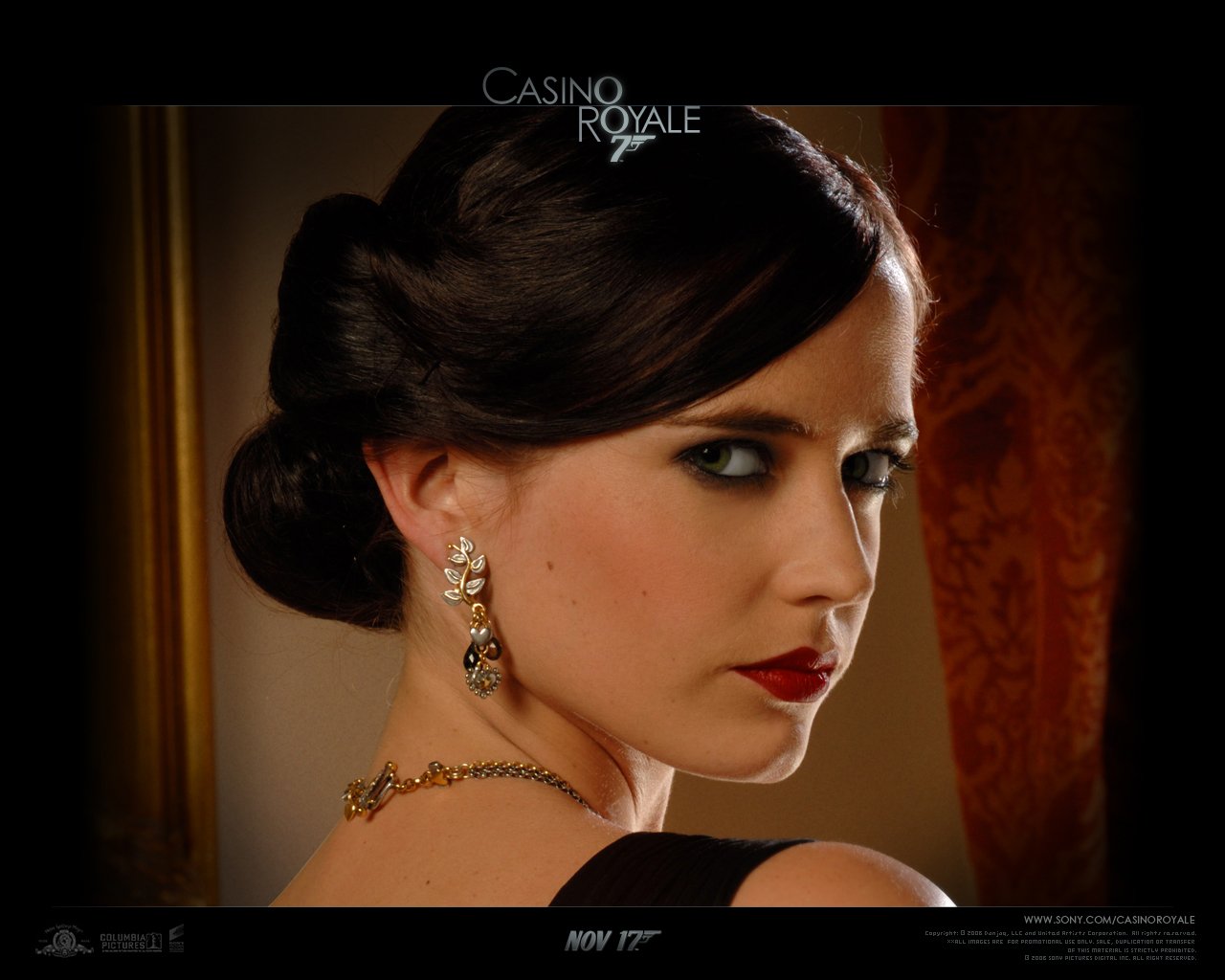 A close-up of actress Eva Green as seen in *Casino Royale*, showcasing her elegant hairstyle, smoky eyes, and bold red lips against a rich, textured background.