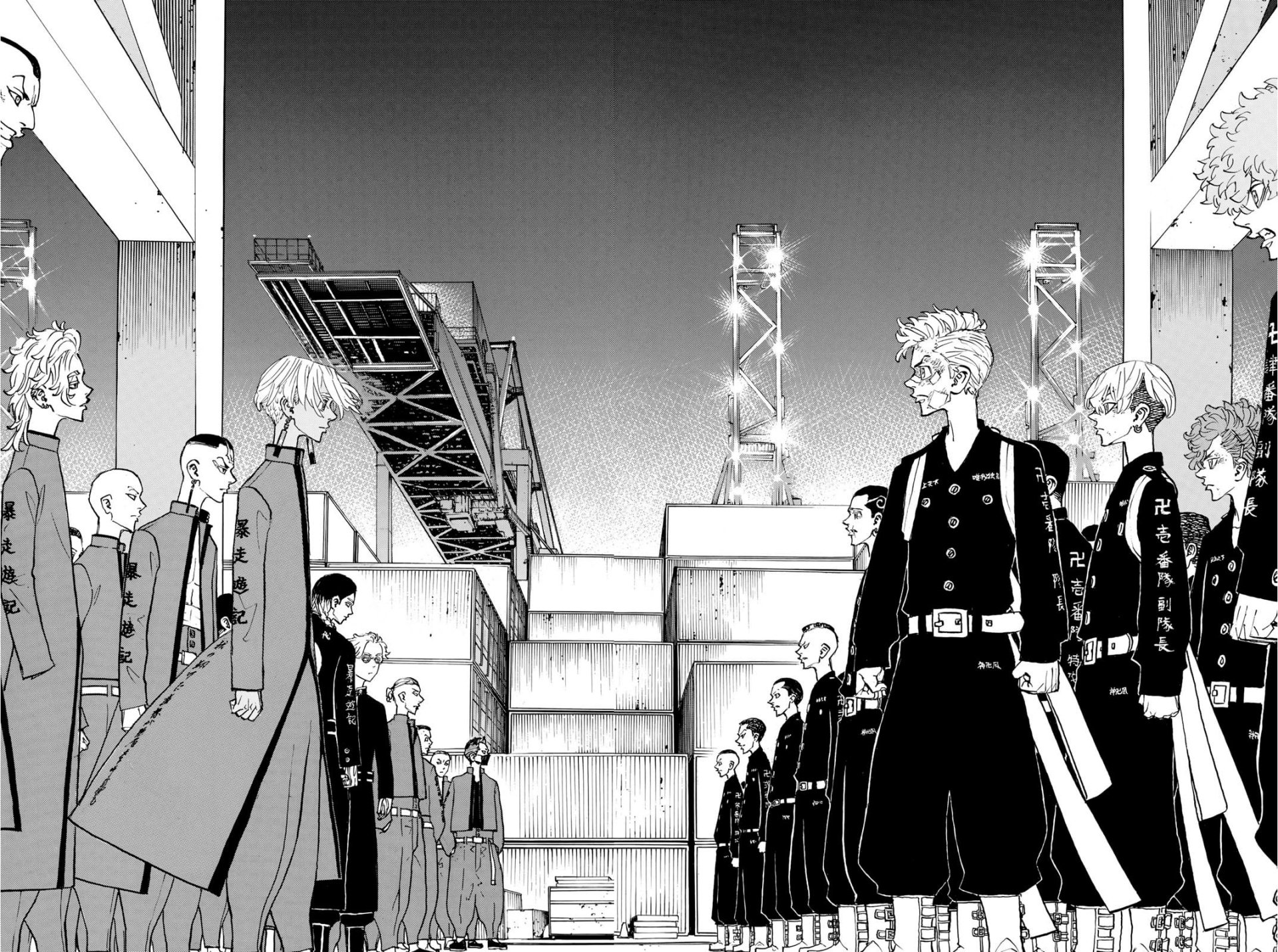 Tokyo Revengers anime/manga scene: two rival gangs in uniforms face off beneath an overpass, leaders standing center in a tense black-and-white standoff.