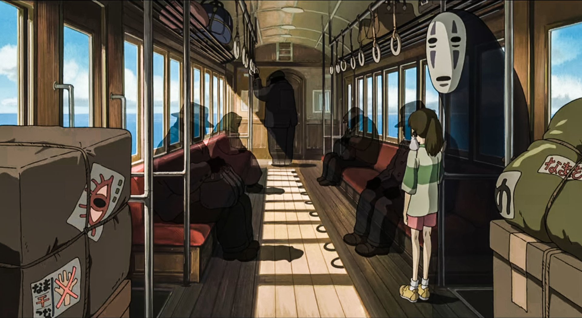 Spirited Away anime: Chihiro stands in a sunlit train carriage facing the masked spirit No-Face, passengers seated and luggage piled as waves roll past the windows.