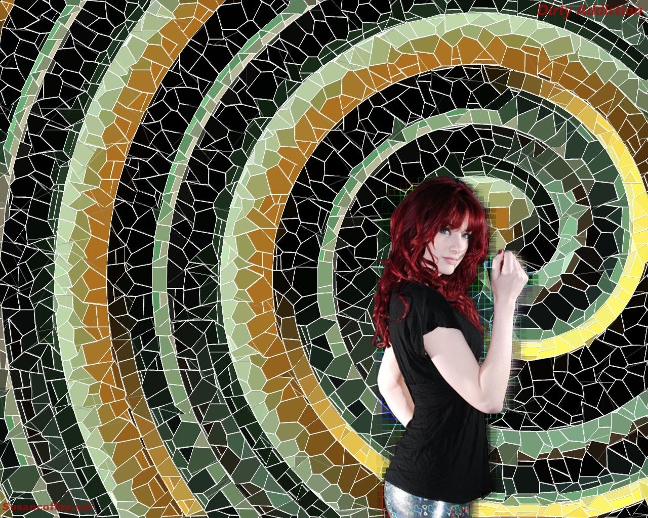 Red-haired woman in a black top and silver leggings poses sideways against a concentric mosaic spiral of green, yellow and brown tiles.