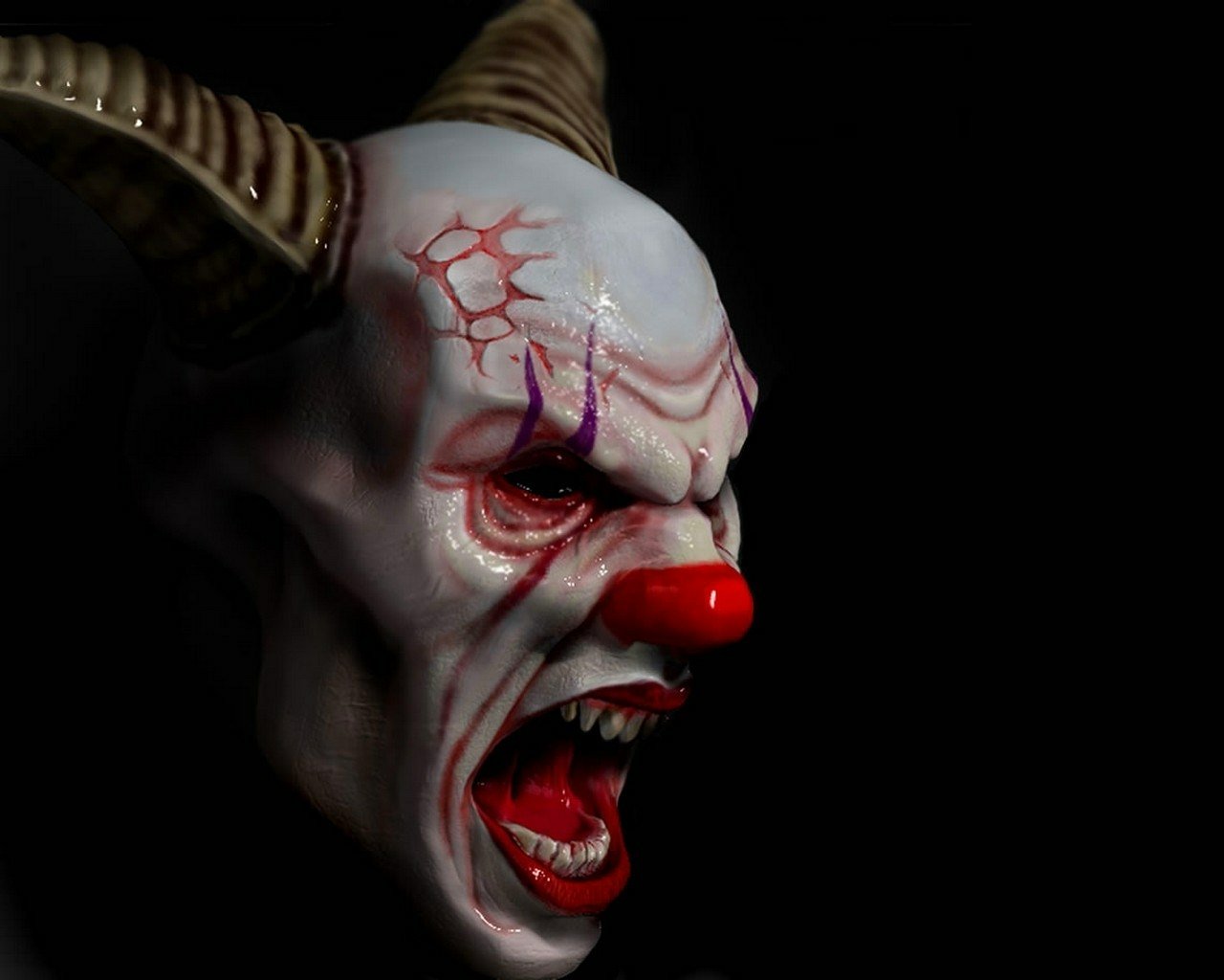 A dark, menacing clown mask features sharp horns, vivid red lips, and fierce eyes, creating an unsettling and eerie atmosphere.