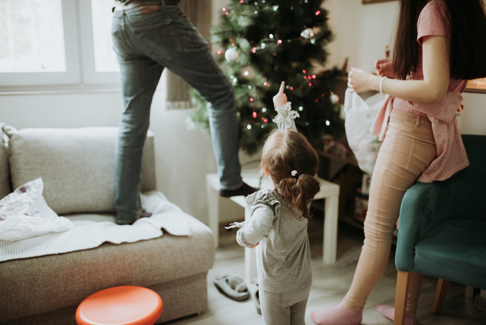  The girl shows with her hand how to decorate the Christmas tree by Nenad Stojkovic