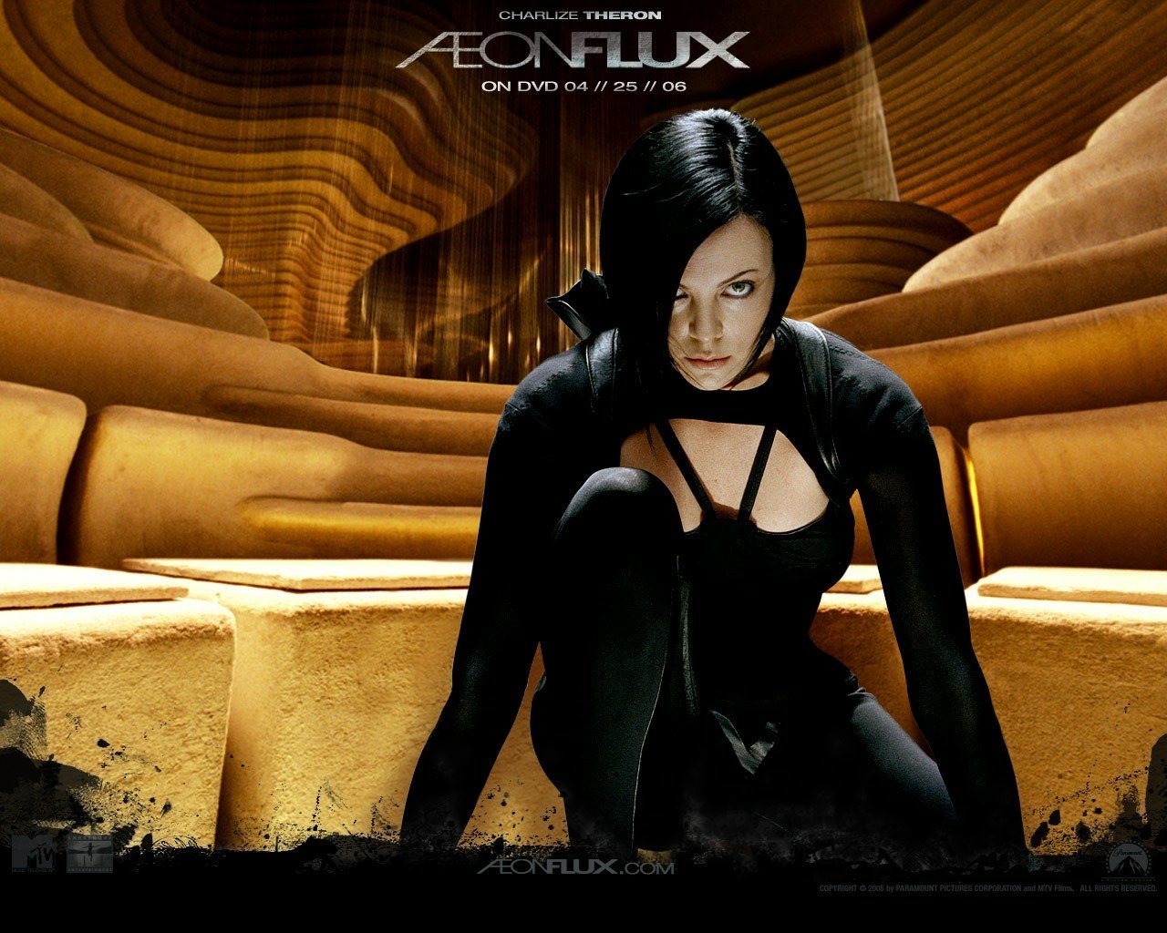 Charlize Theron in a sleek black outfit as Aeon Flux, crouching in a futuristic, sculpted environment from the movie Aeon Flux.