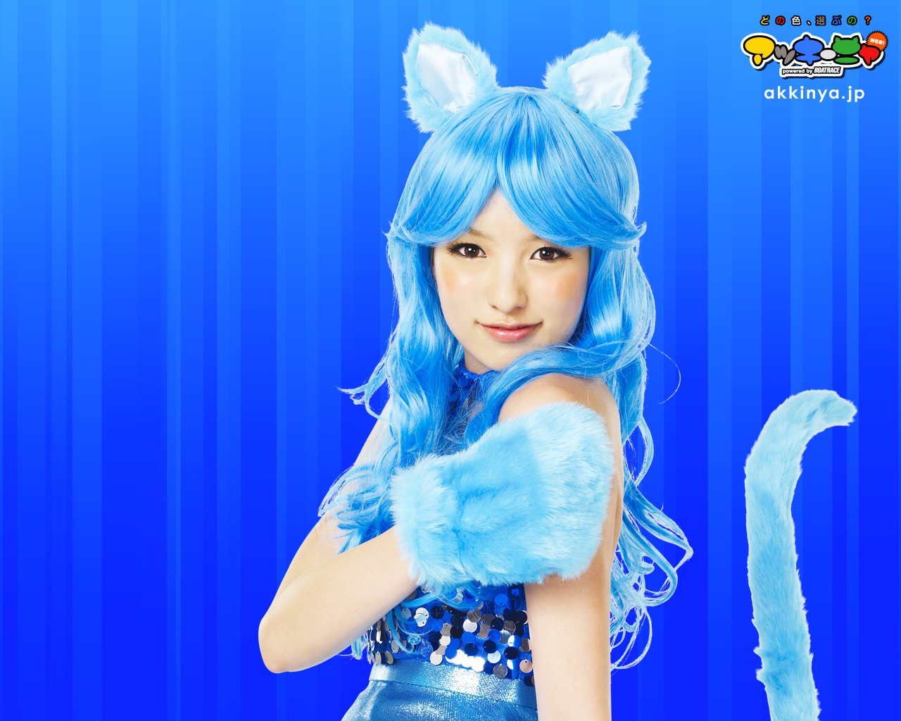 Woman in a blue cat-themed costume with long blue wig, fuzzy ears, tail and paw gloves against a blue striped background. Identity unknown.