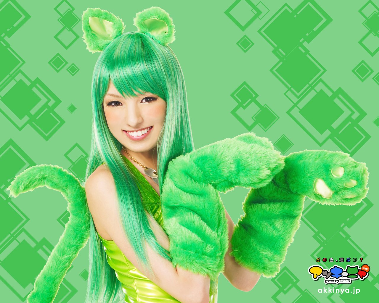 Woman with long green hair and furry green accessories, smiling against a geometric green background, identified as Akina Minami.
