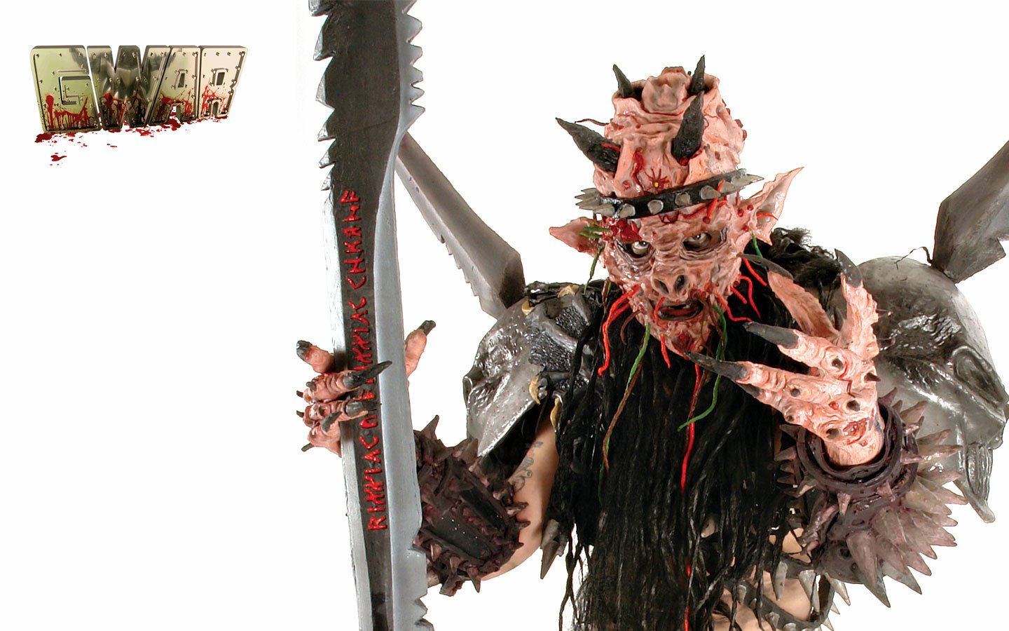 A menacing figure from the band Gwar in detailed monster costume, holding a large weapon and making a rock hand gesture against a white background.