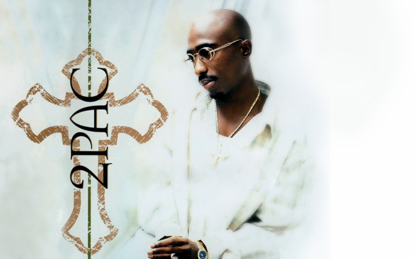 A contemplative 2Pac is featured in a striking image, blending music and spirituality, highlighted by an ornate cross design.