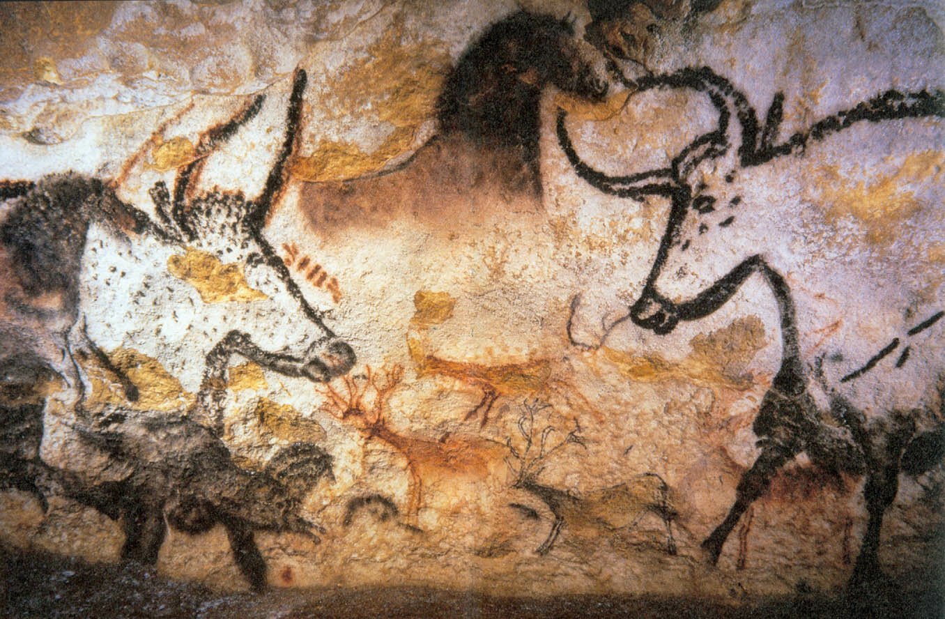 Man-made cave painting depicting various animals, including large bulls and smaller creatures, rendered in earth tones on a textured rock surface.