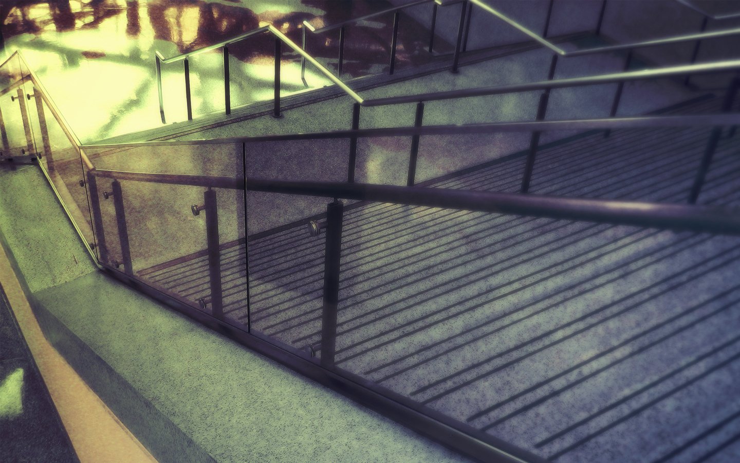 A series of man-made stairs with metal railings casting shadows in soft, angled light.