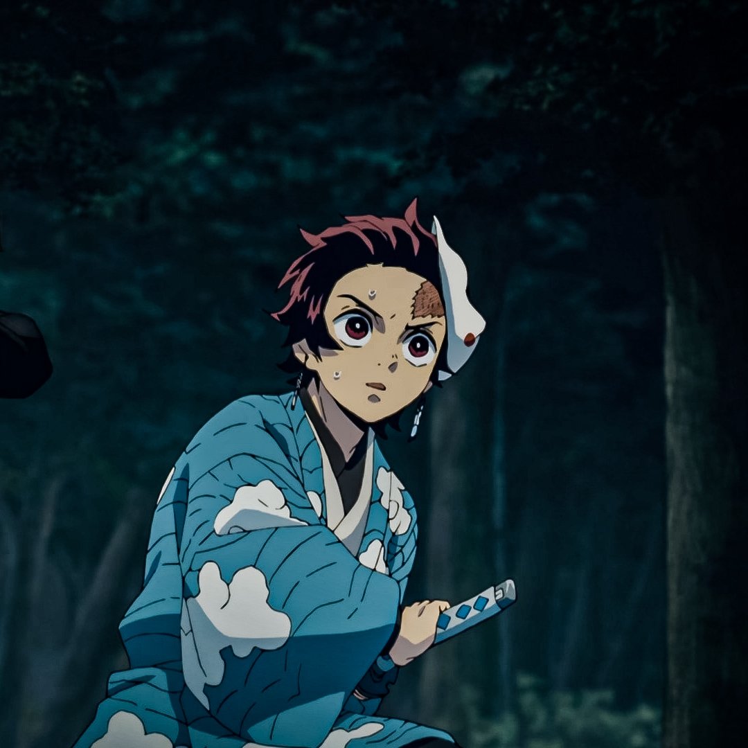 Tanjiro Kamado from Demon Slayer: Kimetsu no Yaiba, in a blue kimono with a half fox mask, crouched in a moonlit forest clutching his sword and looking alert.