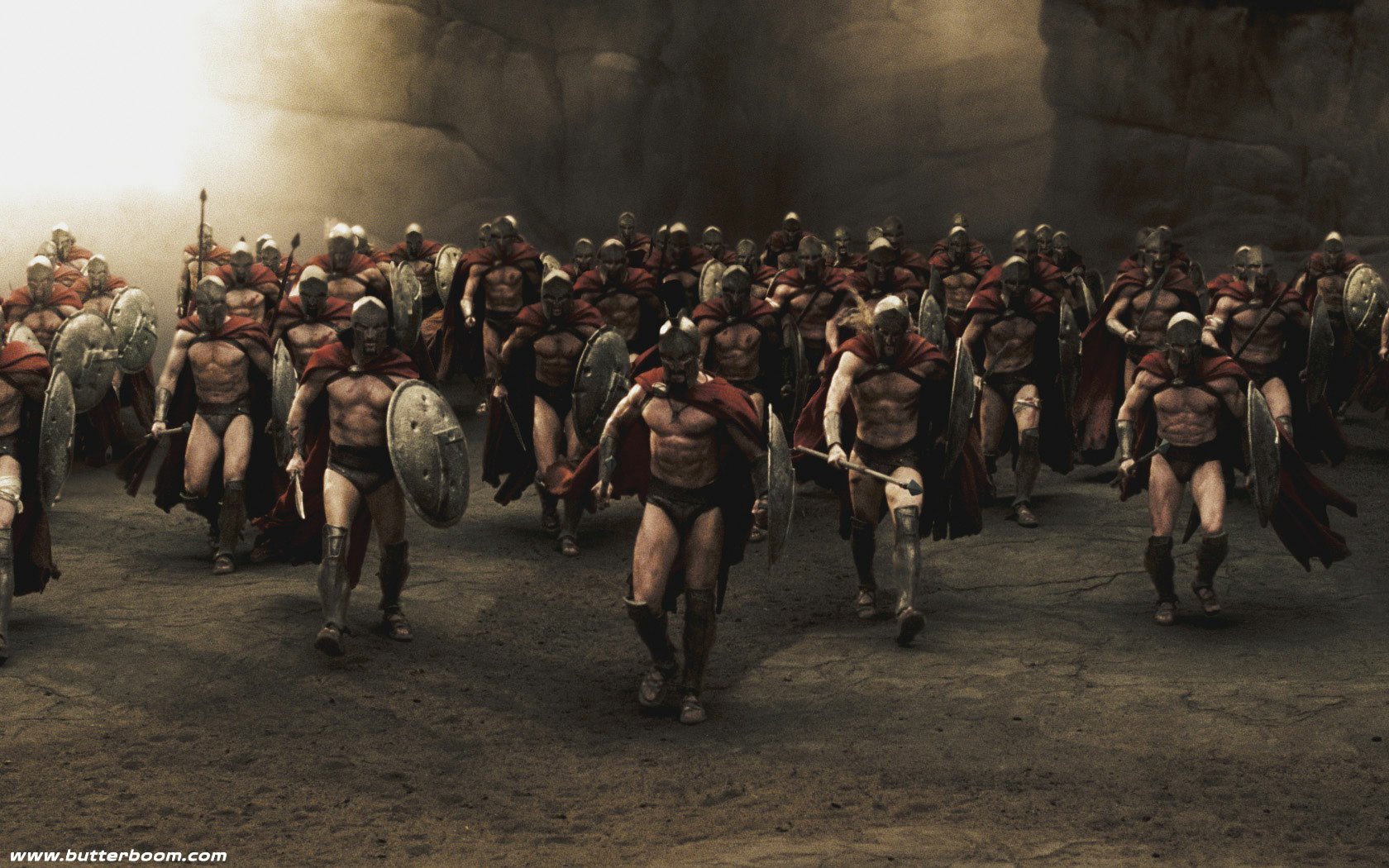 A powerful scene from the movie 300, depicting a united front of muscular Spartans in battle gear, marching together with shields and spears in a dramatic setting.