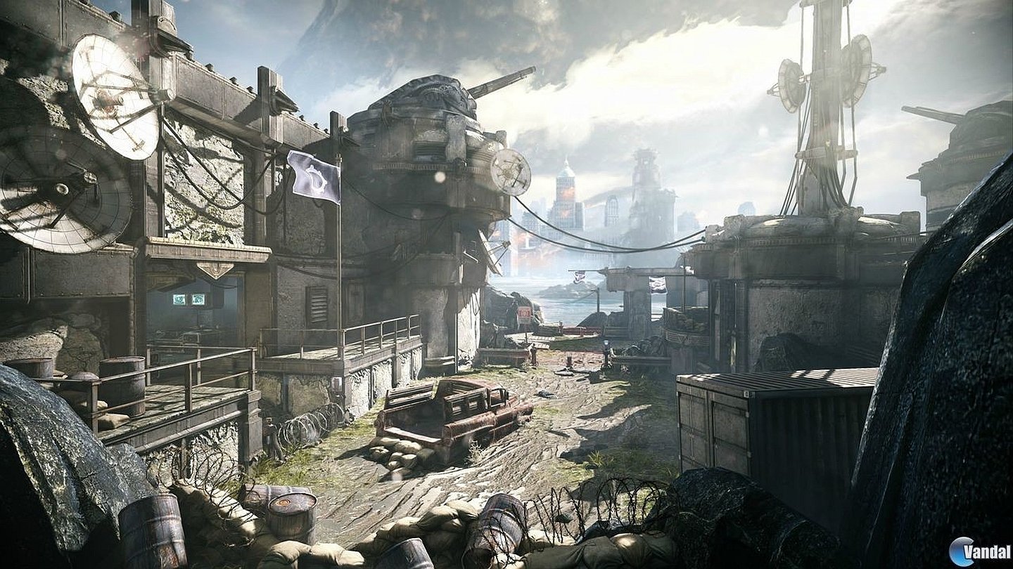 A gritty, war-torn urban environment from the video game Gears Of War: Judgment, featuring damaged buildings, abandoned vehicles, and a cloudy sky.