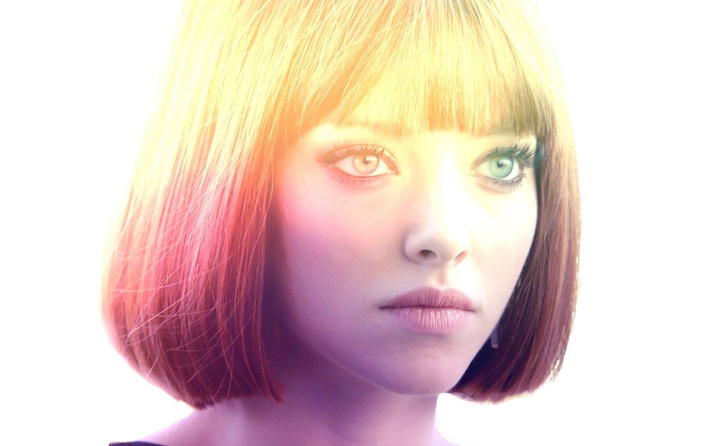 A close-up portrait of celebrity Amanda Seyfried with short blonde hair and soft, colorful lighting enhancing her facial features.