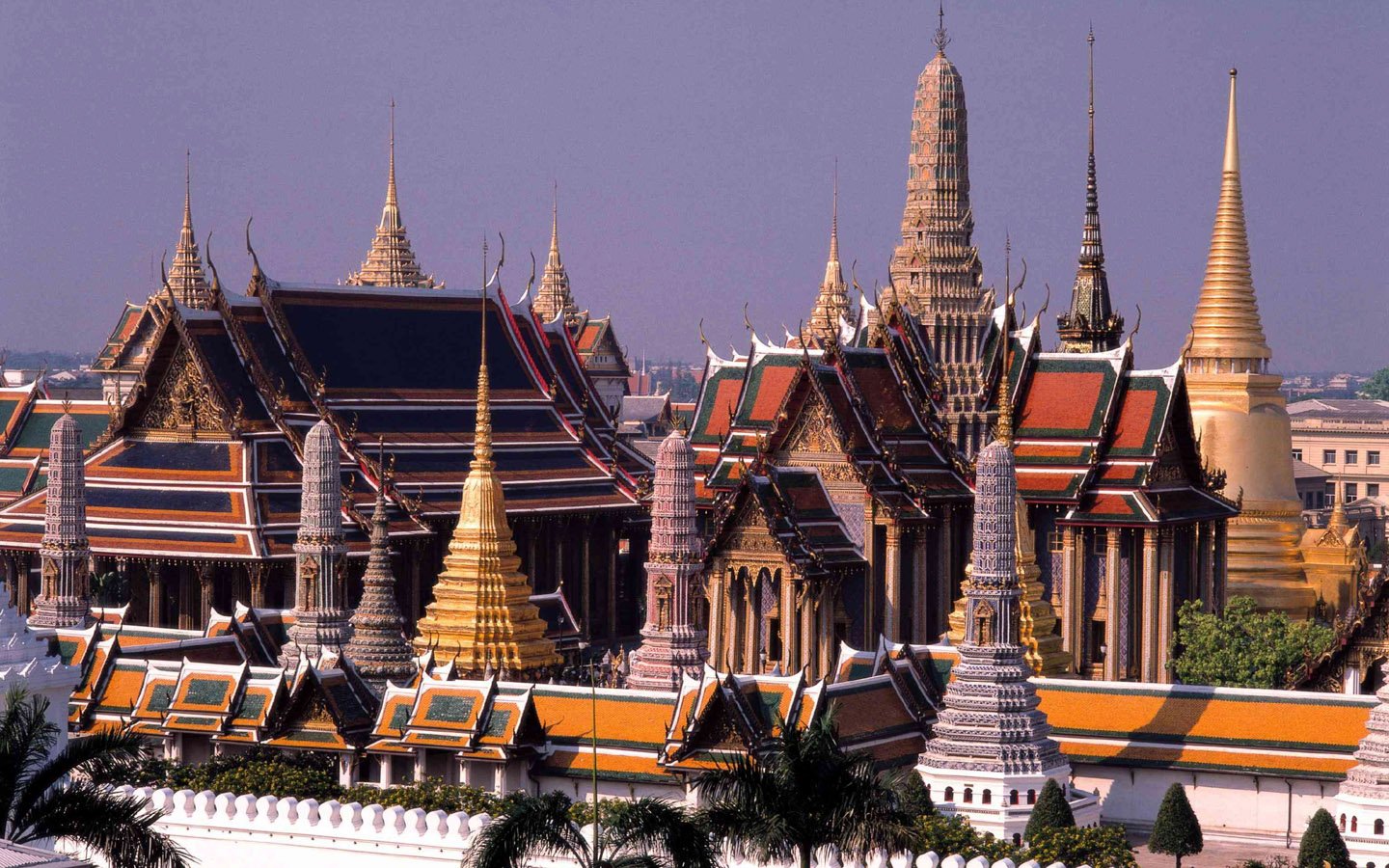 A stunning view of ornate Buddhist temples, showcasing intricate architecture with vibrant colors and towering spires, reflecting the beauty of religious devotion in Buddhism.