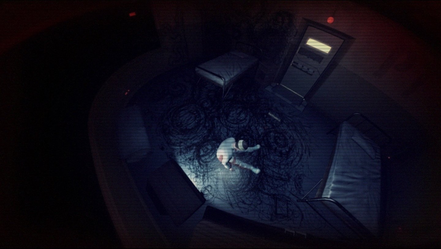 Top-down scene from the video game F.E.A.R. 3: a lone character lies on a dim, circular room floor amid beds and unsettling ritual markings, lit by cold blue light.